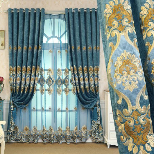 Purple chenille velvet curtains with gold embroidery, tied back to reveal a sheer embroidered curtain behind.