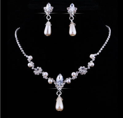 Purple rhinestone and faux pearl necklace and drop earrings set on a black display. Features silver-tone settings. - Image 3