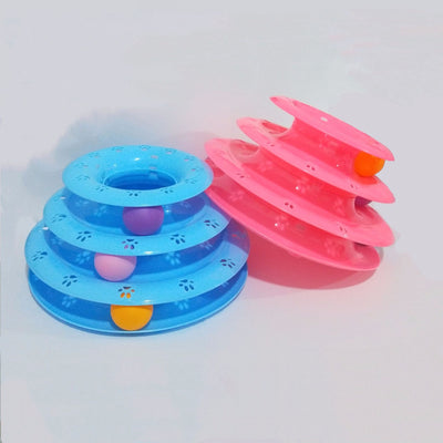 Pink three-tier cat toy with colorful blue, red, and purple balls on tracks, featuring paw print cutouts.