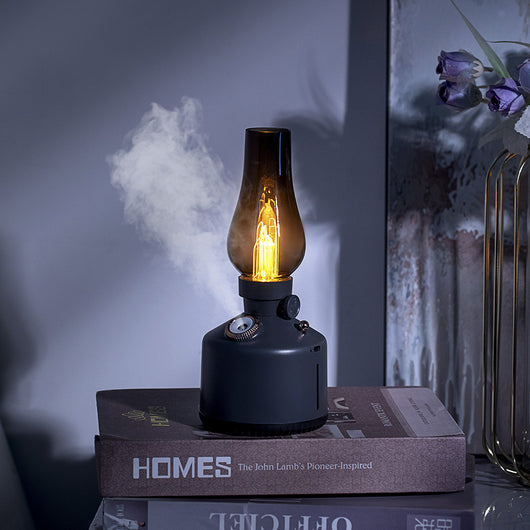 Wood grain kerosene lamp air humidifier with a clear glass-like top and a white light element, featuring a gold control knob.