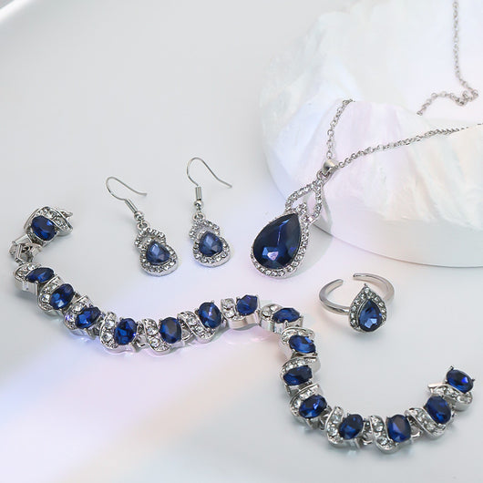 Light luxury jewelry set with silver-tone necklace, dangle earrings, open ring, and bracelet, all featuring emerald green teardrop and oval stones with clear rh - Image 7