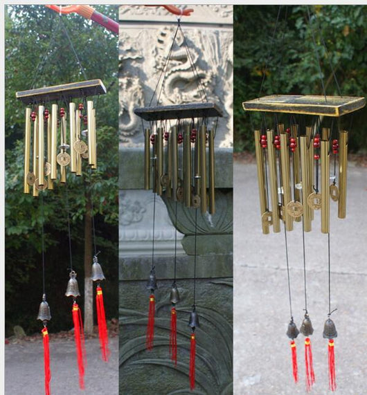 Bronze metal multi-tube wind chime with small bells, decorative coins, and red beads, hanging from a dark wooden disc. - Image 4