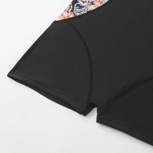 Black one-piece women's swimsuit with colorful floral side panels and boy shorts style bottom. - Image 13