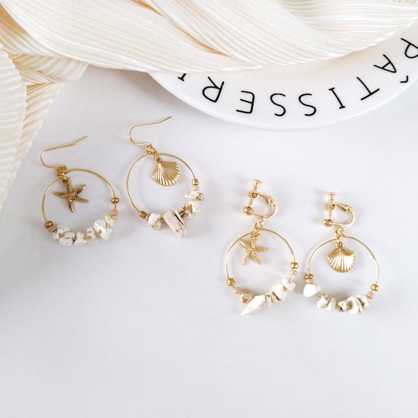 Aretes Estrella de Cinco Puntas en Metal Salvaje con Concha Marina