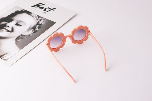 Light blue flower-shaped sunglasses with dark lenses, featuring a playful design and plastic frame. - Image 7