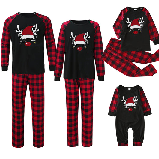 Family matching Christmas pajamas with black tops featuring a wine glass in a Santa hat graphic and red plaid bottoms. - Image 4