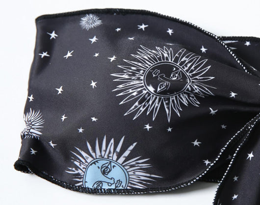 Black celestial print bikini set with a bandeau tie-front top and high-cut bottoms, featuring sun, moon, and star patterns. - Image 17