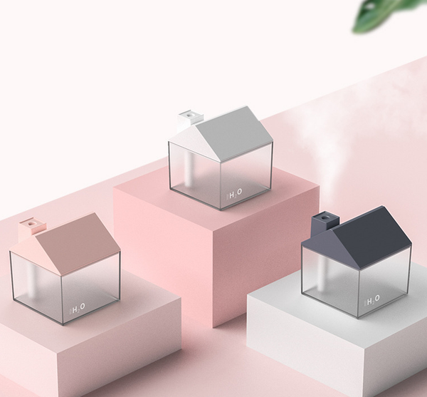 Two house-shaped USB humidifiers, one dark gray and one pink, with clear bases showing H₂O text.