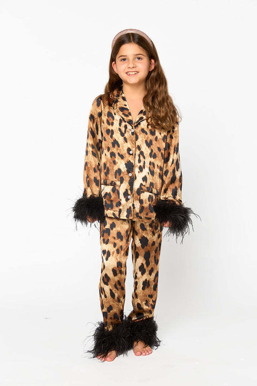 Young girl in a leopard print pajama set with black feather trim on the cuffs and ankles, wearing a pink glitter headband. - Image 17