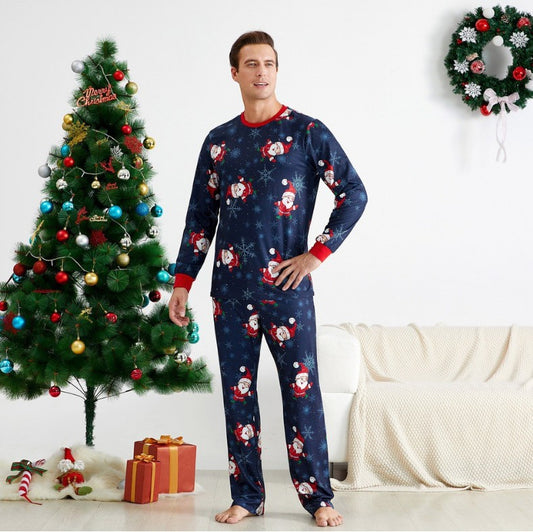 Family of four wearing matching navy blue Christmas pajamas with Santa Claus and snowflake print, red trim. - Image 2
