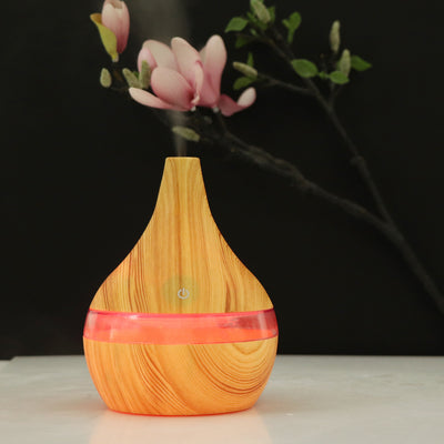 Dark wood grain USB mini tip air purifier and humidifier with a teardrop shape and a silver band. - Image 4