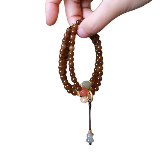 Pulsera de Tres Aros con Perla de Calabaza y Mariposa - Image 5