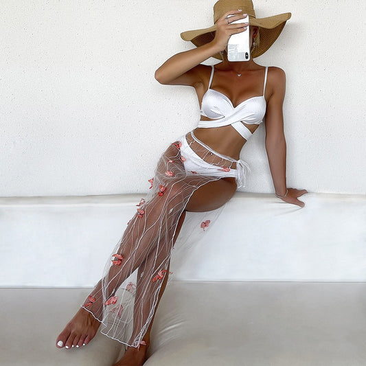 Lavender three-piece swimsuit with a criss-cross bikini top, high-waisted bottoms, and a sheer mesh long skirt with purple floral appliques. - Image 2