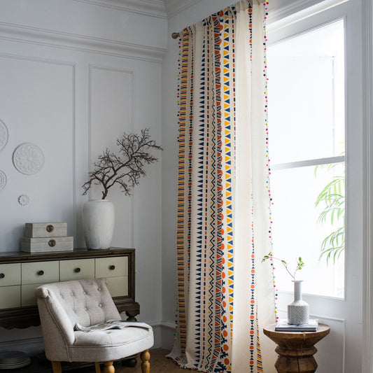 Bohemian cotton and linen curtain with colorful geometric prints and fur ball trim, hanging in a bright room. - Image 2