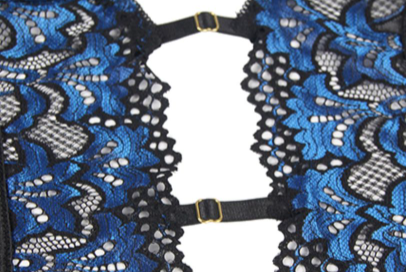 Plus size model in a black and blue lace push-up teddy with garter straps and fishnet stockings. - Image 12