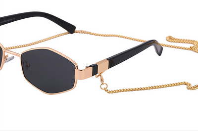 Women's hexagonal sunglasses with dark lenses, gold-colored metal frame, black temples, and a detachable gold chain. - Image 22