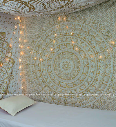 Gold and blue mandala tapestry with elephant and floral patterns, hung above a white quilted bed. - Image 11