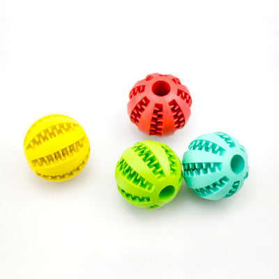 Bright green rubber pet toy ball with textured spikes and ridges for dental cleaning and food dispensing.