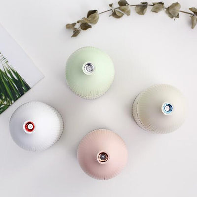 Pink ribbed aromatherapy diffuser and ultrasonic humidifier with a transparent brown base and control buttons. - Image 3