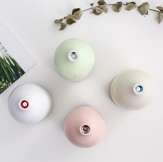 Pink ribbed aromatherapy diffuser and ultrasonic humidifier with a transparent brown base and control buttons. - Image 3