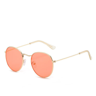 Round gold-framed sunglasses with pink tinted lenses, featuring clear temple tips. - Image 5