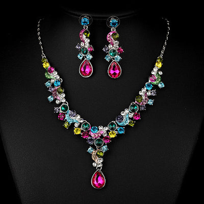 Pink and red rhinestone necklace and matching drop earrings set, featuring teardrop gems and floral scroll design. - Image 3