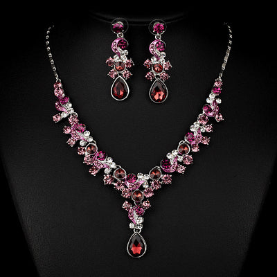Pink and red rhinestone necklace and matching drop earrings set, featuring teardrop gems and floral scroll design. - Image 6