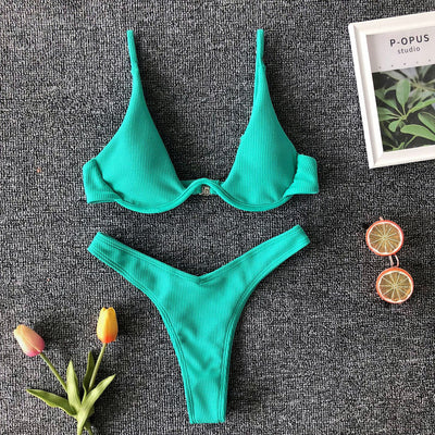 Neon green ribbed two-piece swimsuit with an underwire bikini top and high-cut bottoms on a dark grey background. - Image 17