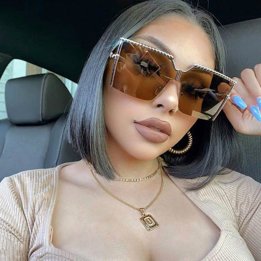 Frameless conjoined sunglasses with gold metal frame and braided detail, featuring brown gradient lenses.