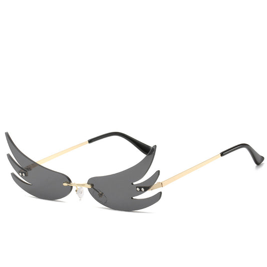 Rimless flame-shaped sunglasses with silver reflective lenses, gold metal temples, and black temple tips. - Image 2