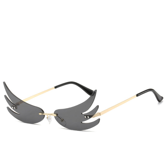 Rimless flame-shaped sunglasses with silver reflective lenses, gold metal temples, and black temple tips. - Image 2