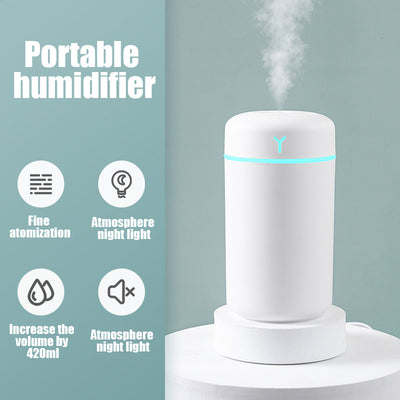Pink portable humidifier with a blue LED light band, emitting fine mist, on a white pedestal. - Image 5