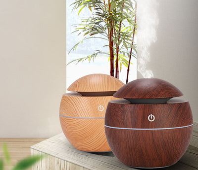 Dark wood grain aroma diffuser and humidifier with a silver power button and accent line. - Image 2