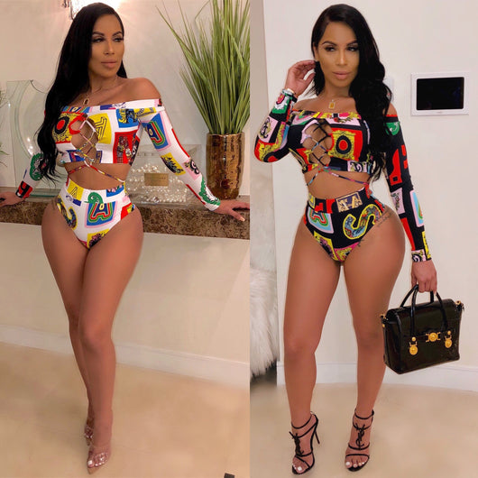 Women's colorful geometric print long-sleeve off-the-shoulder crop top and high-waisted bikini bottom swimsuit.
