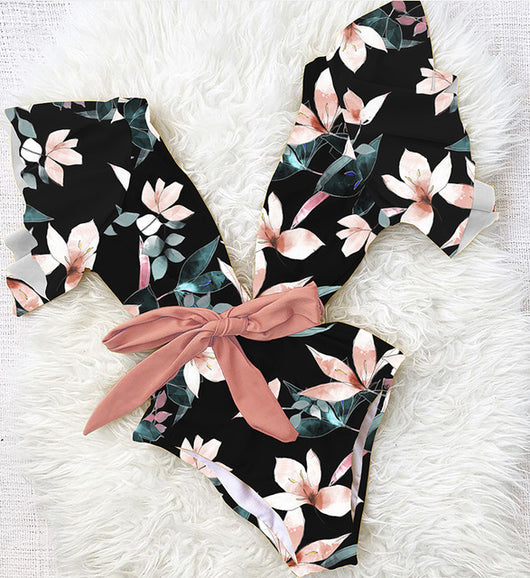 Coral one-piece swimsuit with deep V-neck, ruffled sleeves, and tie-front waist, featuring pink and teal floral print. - Image 13