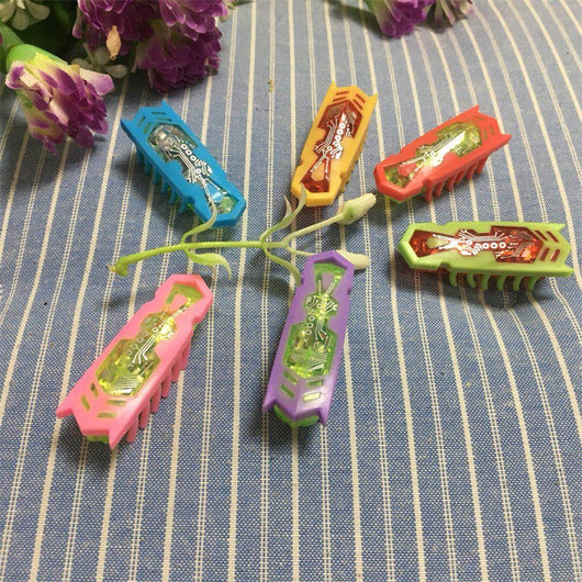 Six colorful electric robotic insect toys in blue, yellow, orange, green, pink, and purple, with visible circuitry.