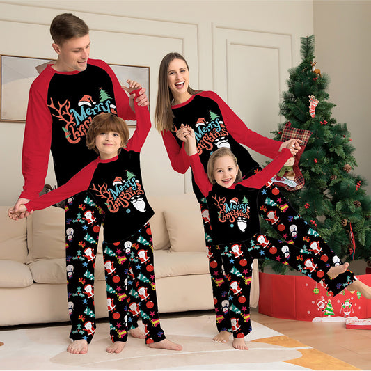 Man wearing a black and red long-sleeve Christmas pajama set with "Merry Christmas" graphic and Santa print pants.