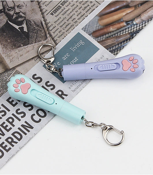 Light purple paw-shaped cat laser pointer toy with USB charging, featuring multiple red laser patterns, soft white light, and UV light. - Image 21