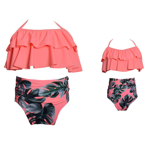 Black wrap bikini top with high-waisted pink and green tropical leaf print swim bottoms. - Image 7