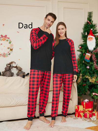 Woman wearing a black long-sleeve pajama top with red and black plaid raglan sleeves and matching plaid pants. - Image 8