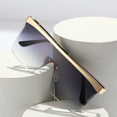 Gold frame square sunglasses with a one-piece gradient blue lens and black temple tips. - Image 11