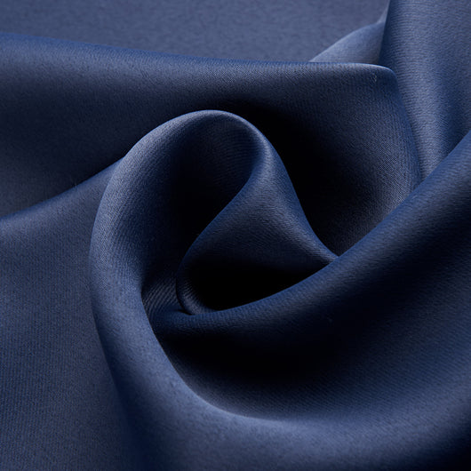 Dark blue blackout curtains with silver grommet tops hanging on a rod in a modern bedroom setting. - Image 11