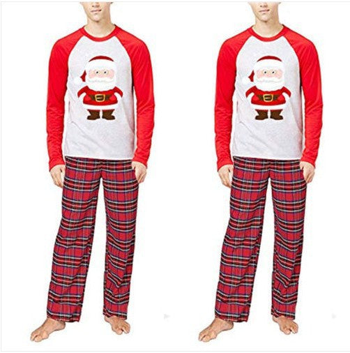Young boy wearing a Christmas pajama set with a grey Santa Claus raglan shirt and red plaid pants. - Image 6