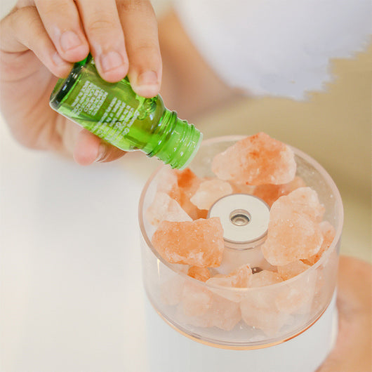 White portable aromatherapy humidifier with a clear top section displaying glowing pink salt crystals and a silver band. - Image 7