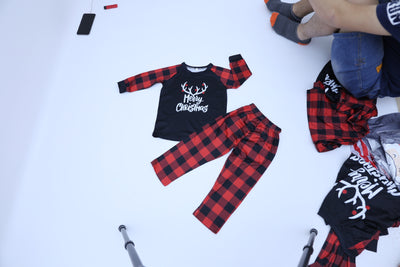 Black and red buffalo plaid pajama set with 'Merry Christmas' and reindeer antlers on the long-sleeved top. - Image 4