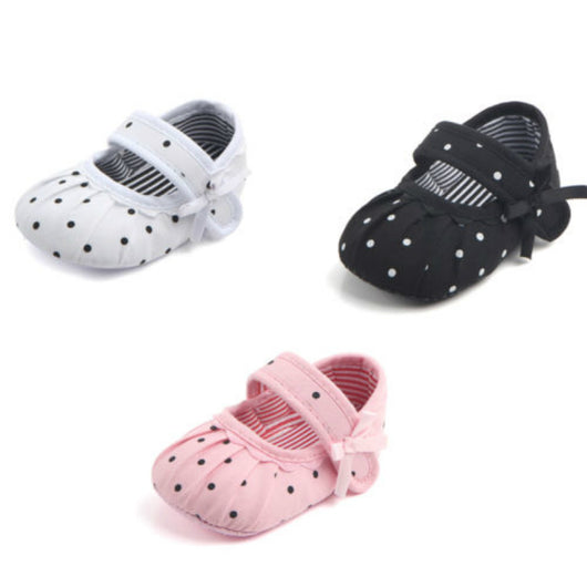 Black baby girl Mary Jane shoes with white polka dots, a strap, bow accent, and striped lining. - Image 7