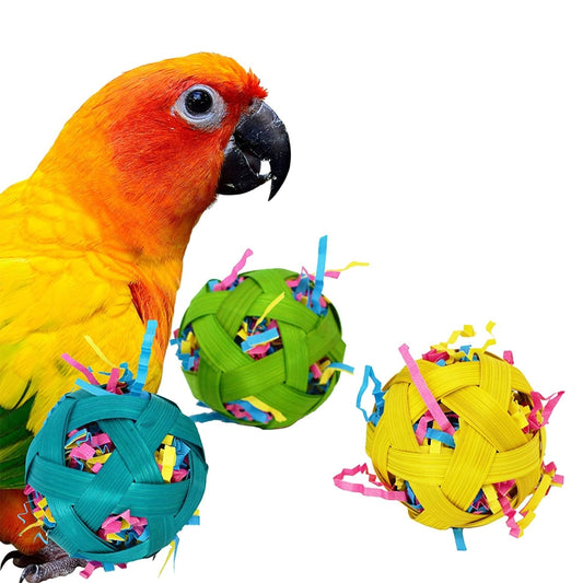 Three colorful woven bamboo toy balls, filled with shredded paper, for small pets to chew and forage.