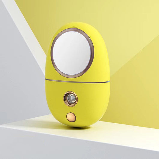 White egg-shaped portable facial humidifier with a pink cartoon rabbit inside a clear dome, gold nozzle and button. - Image 14