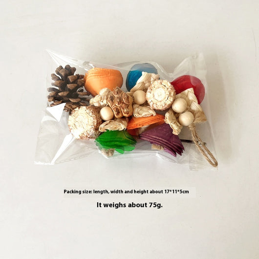 Blue parrot playing with a colorful natural material bird toy featuring corn cobs, wood, and pinecones, hanging in a white birdcage. - Image 13
