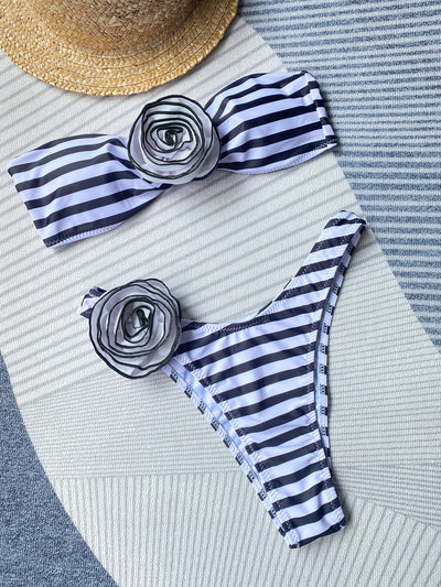 Black tube top bikini with white three-dimensional flower embellishments, worn by a woman partially submerged in water. - Image 15